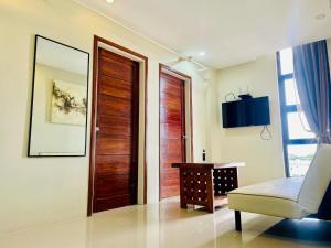 a room with a door and a chair and a table at Hotel Elegant La Union in San Fernando