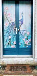 a door with a painting of a peacock on it at Appartement confortable Pouxeux / 70 m² / superbe jardin in Pouxeux