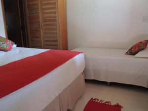 
a bedroom with a bed and a dresser at Nossa Casa em Jeri in Jericoacoara
