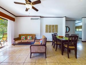 a living room with a ceiling fan and a table and chairs at Catalina Cove 3- 6 Bedroomloft Home in Brasilito