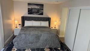 a bedroom with a large bed with two lamps at Prime Lux Modern & Cozy Studio in Salt Lake City