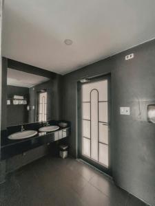 a bathroom with two sinks and a large window at Ly Ky Hotel in Quy Nhon
