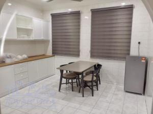 a kitchen with a table and chairs and a refrigerator at Royale Villa Private Pool Batu Gajah Ipoh Perak in Batu Gajah