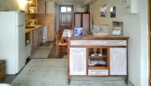 a kitchen with a table and a refrigerator at Appartement cosy à Tarbes - Terrasse et jardin clôturé in Tarbes