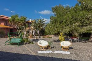 a park with two chairs and a playground at Agriturismo Le Mimose in Arborea 