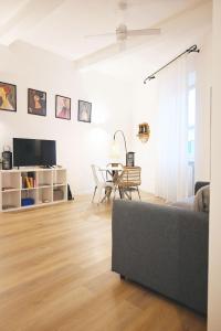 a living room with a couch and a table at Cozy Stay in City Center in Livorno +29 photos