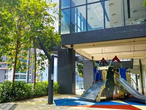 a small airplane on a slide in front of a building at Tropicana 218 Macalister by NGN in George Town