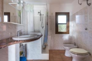 a bathroom with a sink and a toilet and a shower at Agriturismo Le Mimose in Arborea  +135 photos
