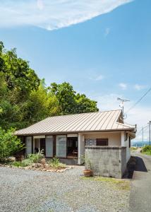 a house with a metal roof on a street at 網ノ屋 - Aminoya Beach House Ezura in Shirahama