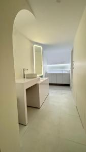 a white bathroom with a sink and a mirror at 16 Post Station Single Tour in Hengchun +17 photos
