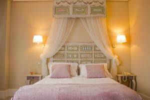 a bedroom with a large bed with a canopy at Ares Hotel in Zamora