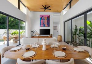 a dining room with a wooden table and chairs at Villa Amour 3 Bedroom Spa Pool Retreat near Beach - Lamai in Amphoe Koh Samui