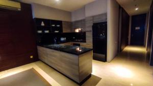 a kitchen with a counter with a sink in it at Apartment 3BR with River View in City Center at Sumatra36 Surabaya By Travelio in Surabaya