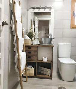 a bathroom with a toilet and a sink and a mirror at Charming apartment in Cuenca with fireplace - 80 sqm in Cuenca