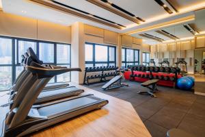 a gym with treadmills and exercise equipment in a building at Agile Bukit Bintang TRX Pavilion KL by WSD in Kuala Lumpur