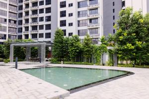 a swimming pool in front of a tall building at Agile Bukit Bintang TRX Pavilion KL by WSD in Kuala Lumpur