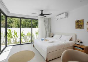 a bedroom with a bed and a large window at Villa Amour 3 Bedroom Spa Pool Retreat near Beach - Lamai in Amphoe Koh Samui +23 photos