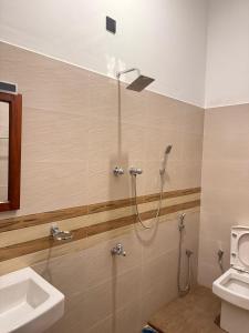 a bathroom with a shower and a sink at Ocean Bliss Villa Mirissa in Kamburugamuwa