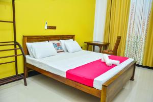 a bedroom with a large bed with a red blanket at Ocean Bliss Villa Mirissa in Kamburugamuwa +61 photos