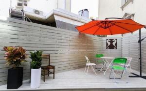 a patio with a table and chairs and an umbrella at Best In City Hotel in Daejeon