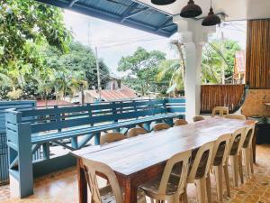 a wooden table and chairs in a room at Full House in El Nido