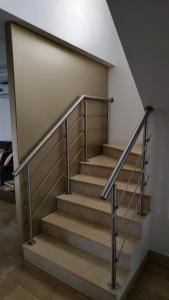 a set of stairs with a metal railing at Casa Moderna con Piscina y Espacios al Aire Libre en Ciudad Celeste, Samborondón in Barranco