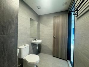 a bathroom with a toilet and a sink at X - The Subiaco - Edumetro Subang Jaya in Subang Jaya +8 photos