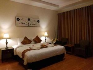 Una habitación de hotel con una cama grande y una silla. en Sea Coral Beach Resort, en Kawal 10 fotos más