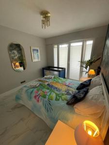 a bedroom with a large bed with a colorful bedspread at St George in Antibes