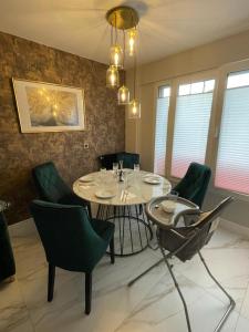 a dining room with a table and green chairs at St George in Antibes