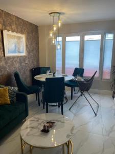 a living room with a couch and tables and chairs at St George in Antibes