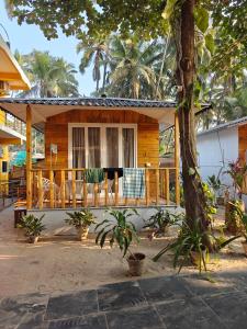 a house with a porch with chairs on it at Rococo Pelton beach huts Palolem Beach goa in Palolem