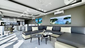 a living room with a couch and a table at Sawansa 33A 400m2 Luxury Seaview Pool near Beach in Patong Beach