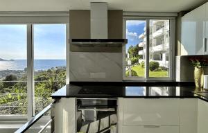 a kitchen with a view of the ocean at Sawansa 33A 400m2 Luxury Seaview Pool near Beach in Patong Beach