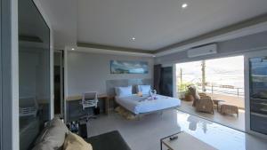 a bedroom with a bed and a living room at Sawansa 33A 400m2 Luxury Seaview Pool near Beach in Patong Beach +26 photos