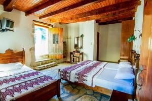 a bedroom with a bed and a desk in it at Vafes Traditional Stone Houses in Vafés