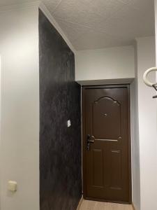 a door in a room with a black wall at Väikekorter in Pärnu