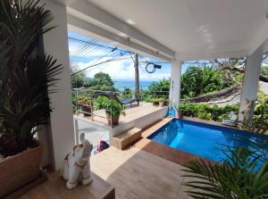 a house with a swimming pool and a view of the ocean at Sawansa 33B 425m2 Luxury Seaview Pool near Beach in Patong Beach