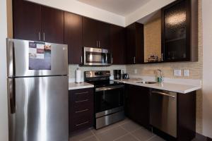 a kitchen with a stainless steel refrigerator at Residence Inn by Marriott Oklahoma City North/Quail Springs in Oklahoma City