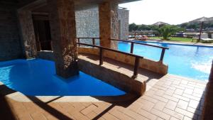 a swimming pool with blue water in a building at Simosmare Resort in Elafonisos
