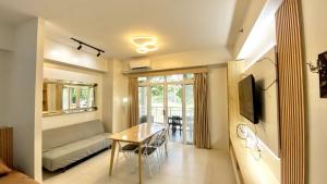 a living room with a table and a couch at Pico de Loro 2BR Spacious Modern Zen with Lagoon View in Nasugbu