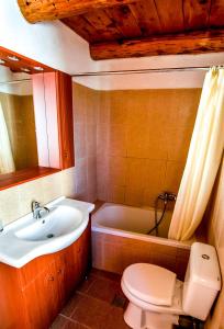 a bathroom with a sink and a toilet and a tub at Vafes Traditional Stone Houses in Vafés +79 photos