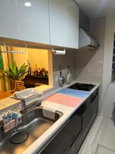 a kitchen with a sink and a stove at Memories-Inn in Noda