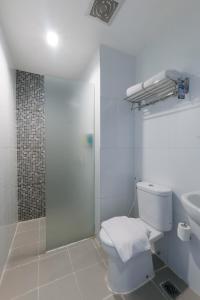 a bathroom with a shower and a toilet and a sink at Hotel 88 Mangga Besar 62 - Best Breakfast - Near By Ancol And Government Center in Jakarta