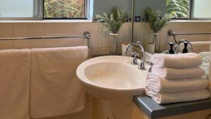 a bathroom with a sink and towels at Sandalwood in Culburra Beach +18 photos