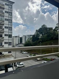 a view of a parking lot with cars and buildings at AYAAN BLOSSOM BUDGET HOMESTAY FREE WiFi and Netflix in Tanah Rata