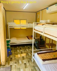 a room with three bunk beds in it at The Lana Ho Tram Homestay in Xuyên Mộc