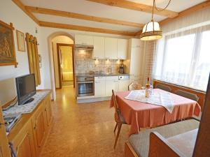 a kitchen with a table with a red table cloth at Apartment in Pitztal near Ski Slopes in Arzl im Pitztal