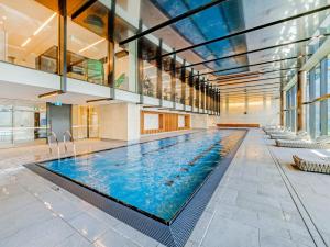 a large swimming pool in a building at Pars apartments - Melbourne Quarter- unique View of city and Yarra in Melbourne