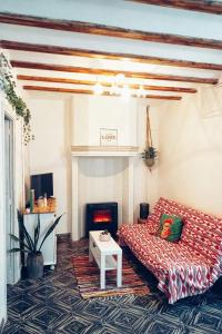 a living room with a couch and a fire place at Casa Maibeca in Bolbaite